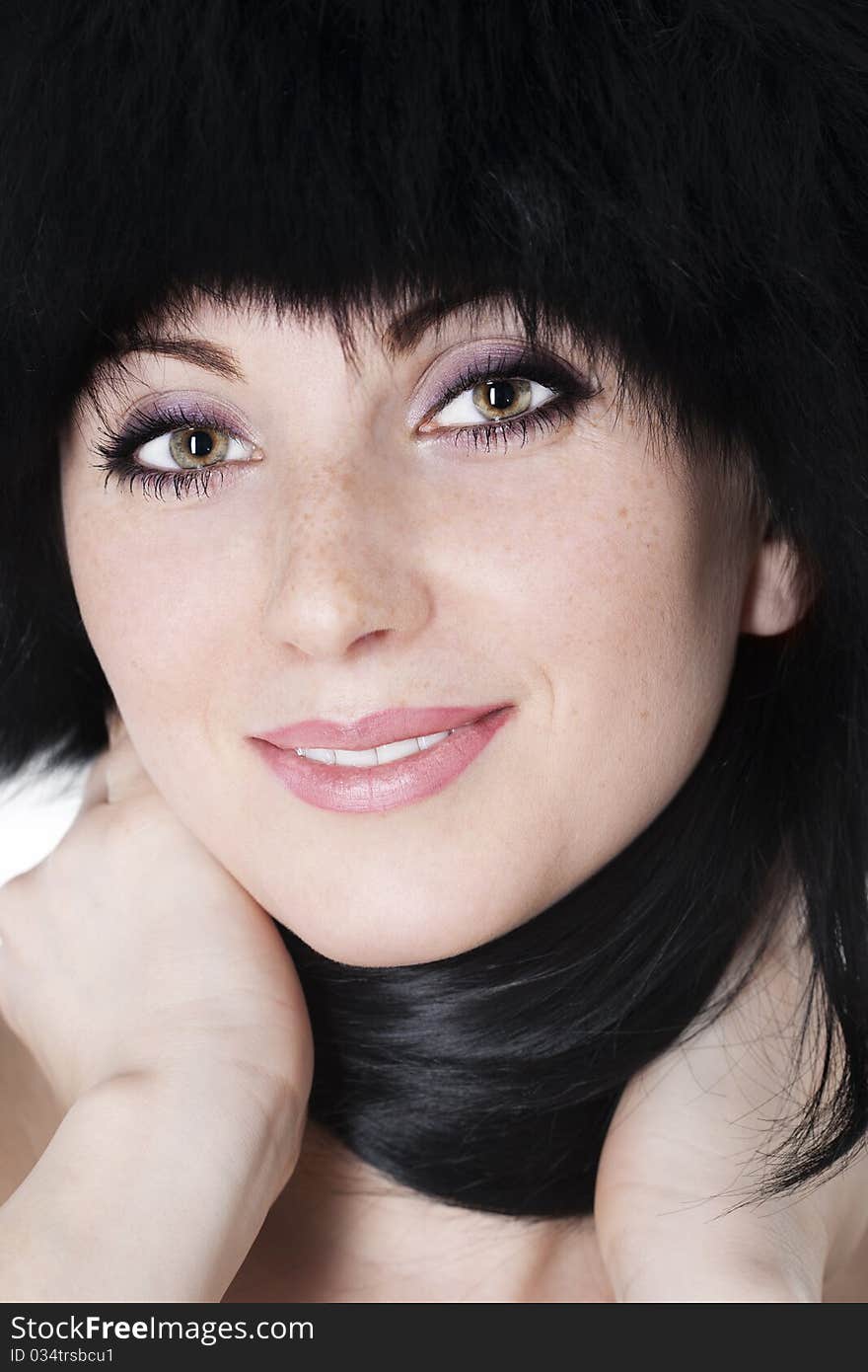 Close-up portrait of beautiful young woman wearing fur hat. Close-up portrait of beautiful young woman wearing fur hat