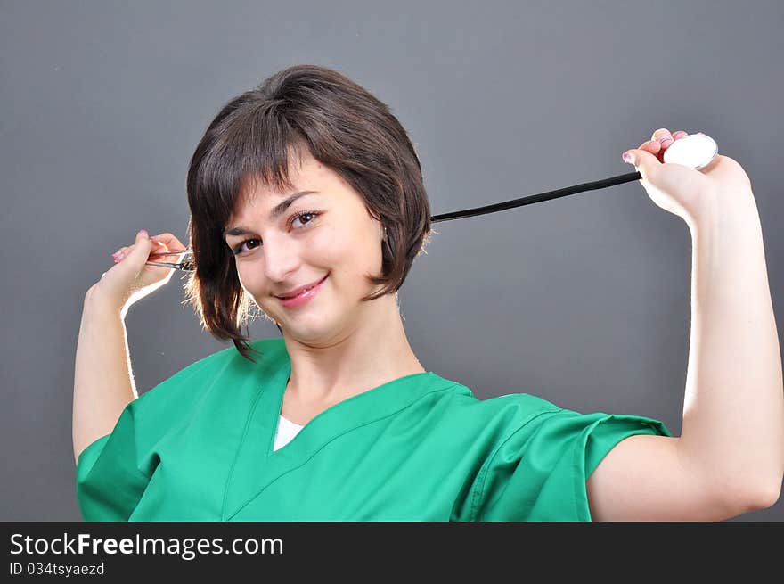 Attractive lady doctor on a over gray background