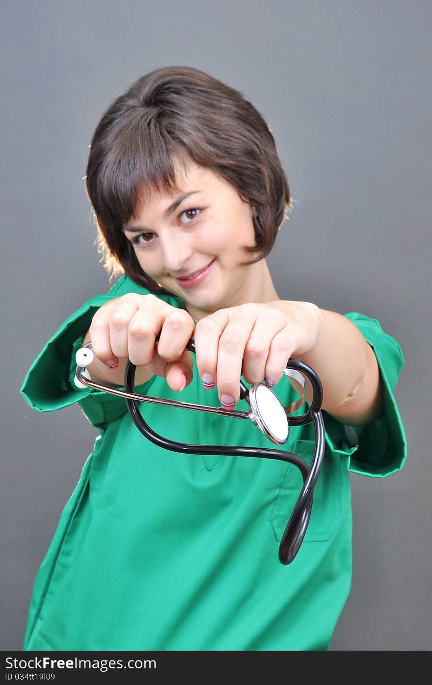 Attractive lady doctor on a over gray background