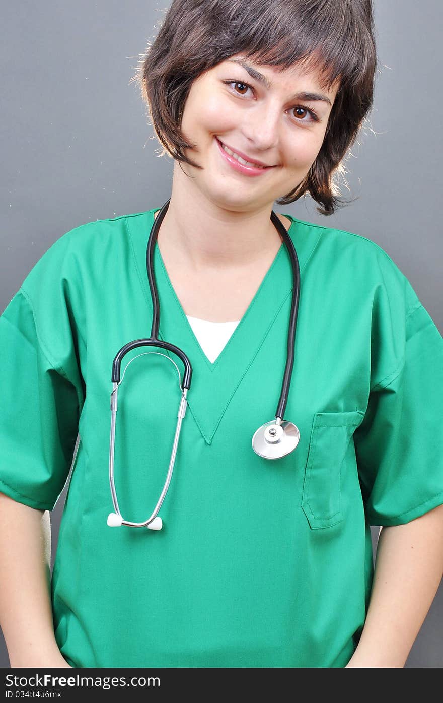 Attractive lady doctor on a over gray background