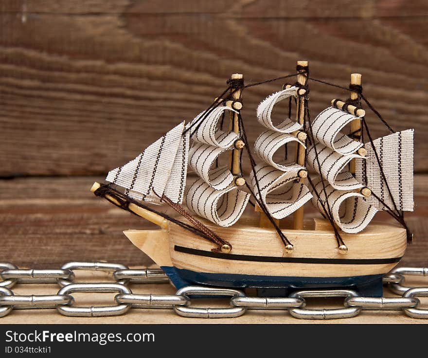 Model ship on wood background