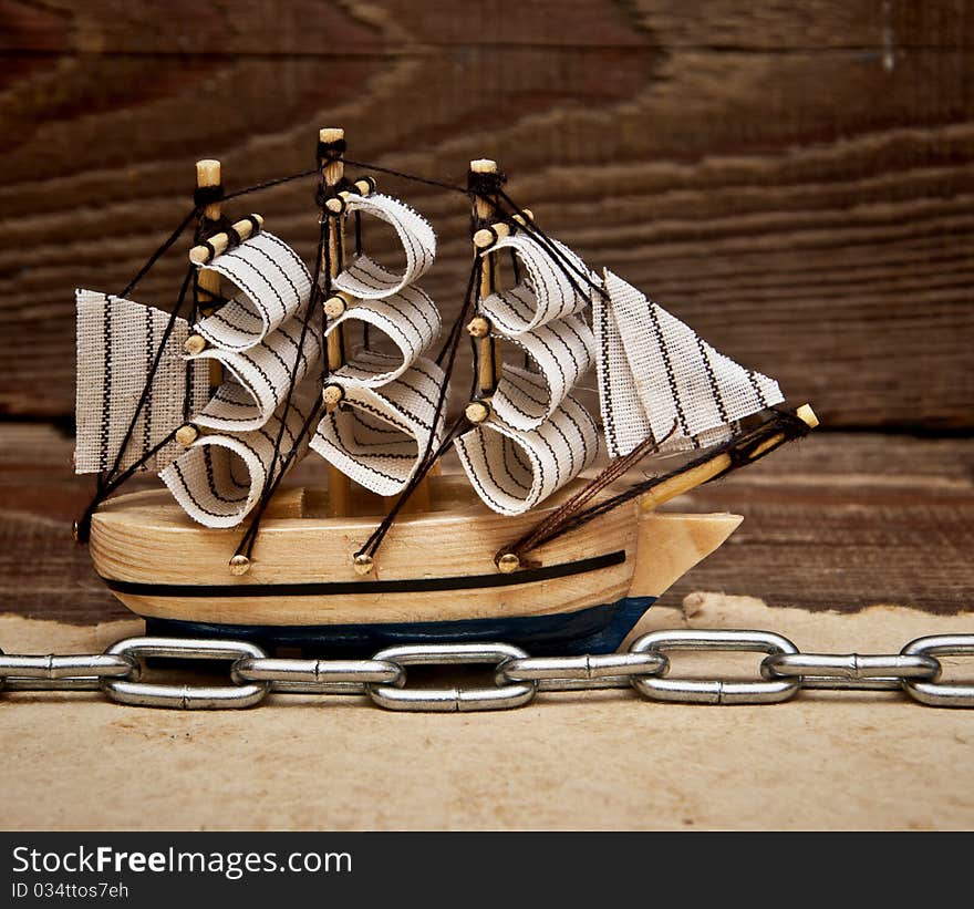 Model ship on wood background