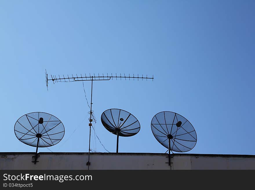 Satellite dish on blue sky background