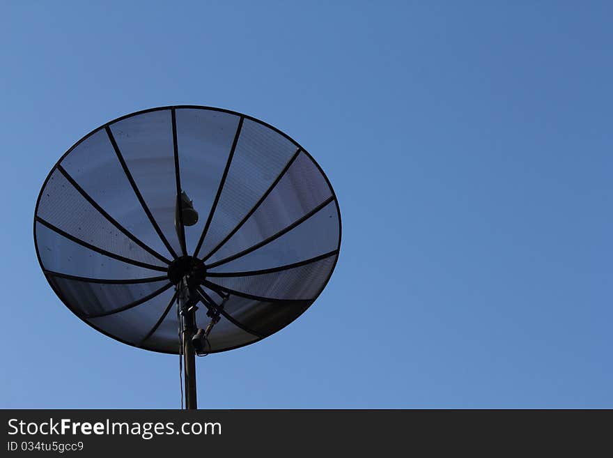 Satellite dish on blue sky background