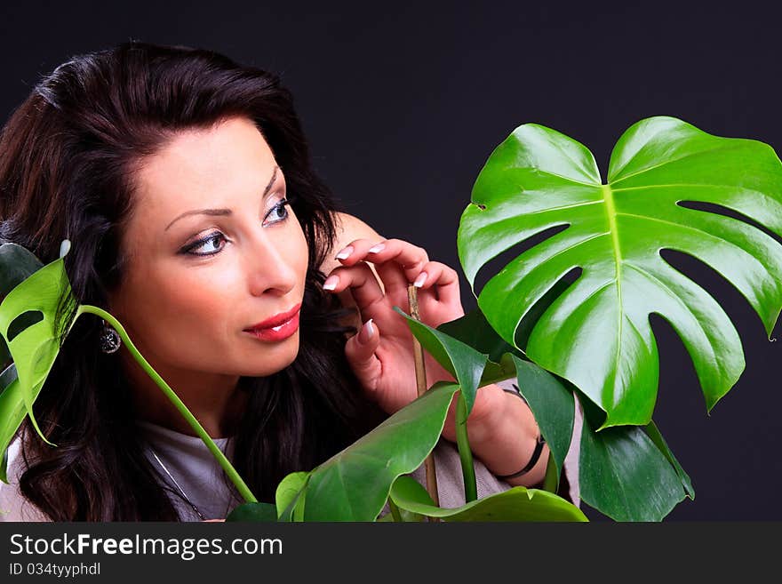 Beautiful brunette looks out for the plants