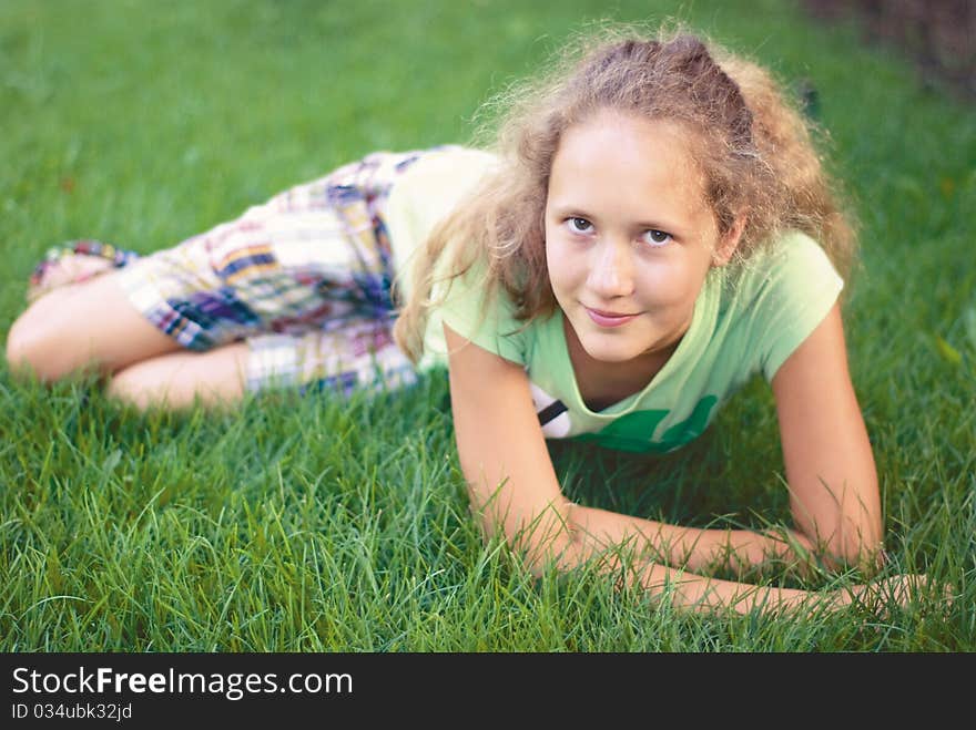 A young girl on green grass