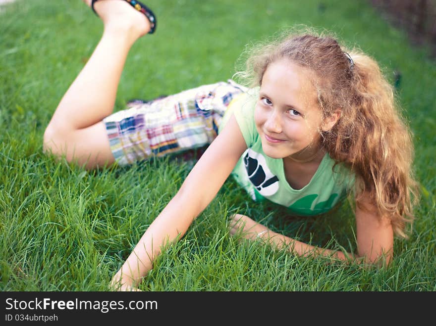 A young girl on green grass