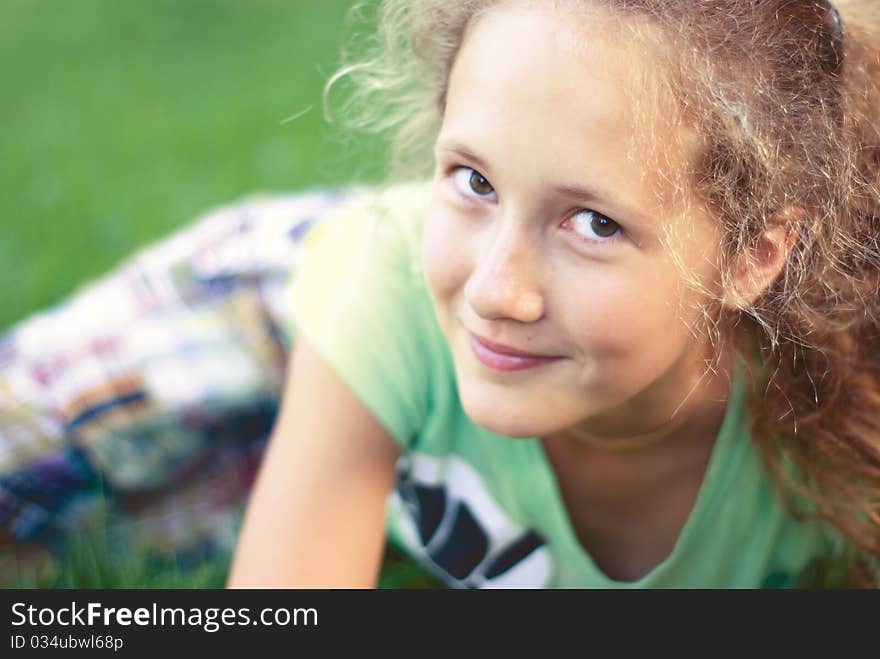 A young girl on green grass