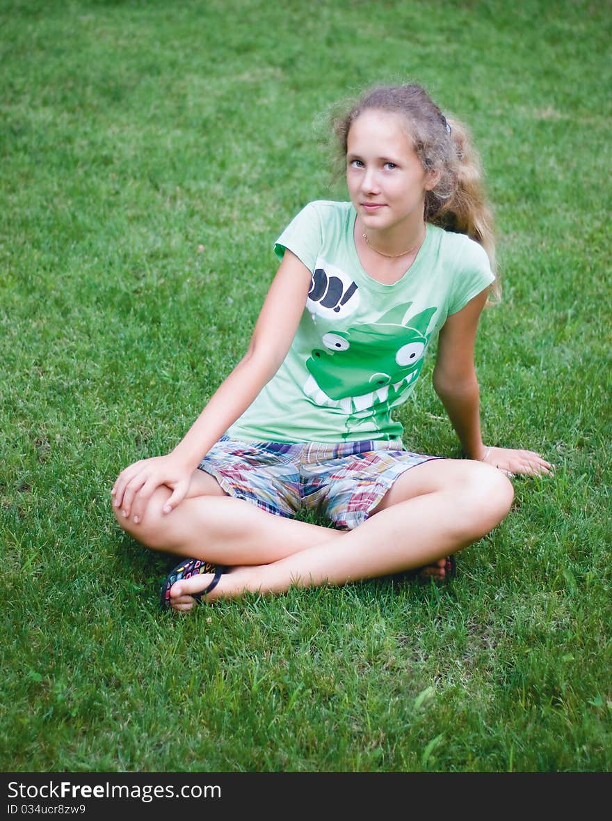 A young girl on green grass