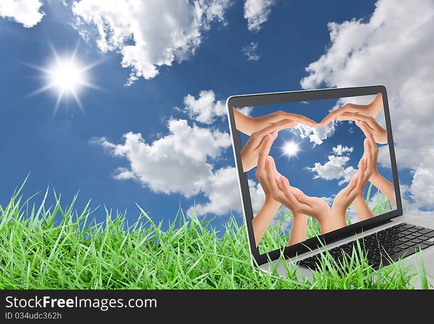 Notebook on grass with blue sky