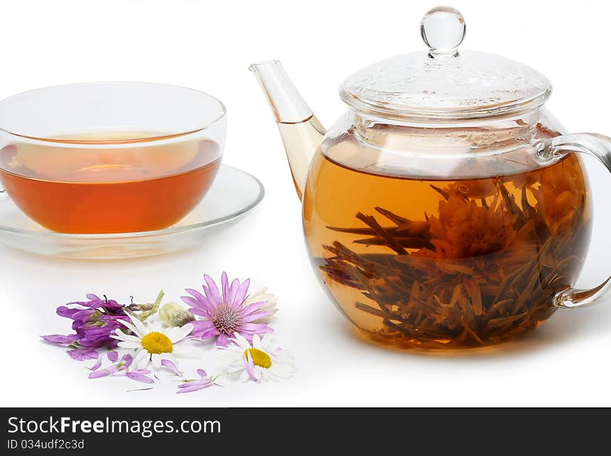 Teapot with floral brewed tea and flowers