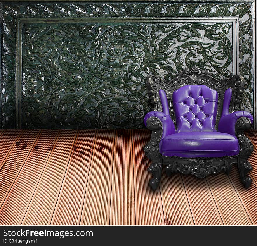 A violet sofa with carving wooden wall, vintage style decoration. A violet sofa with carving wooden wall, vintage style decoration