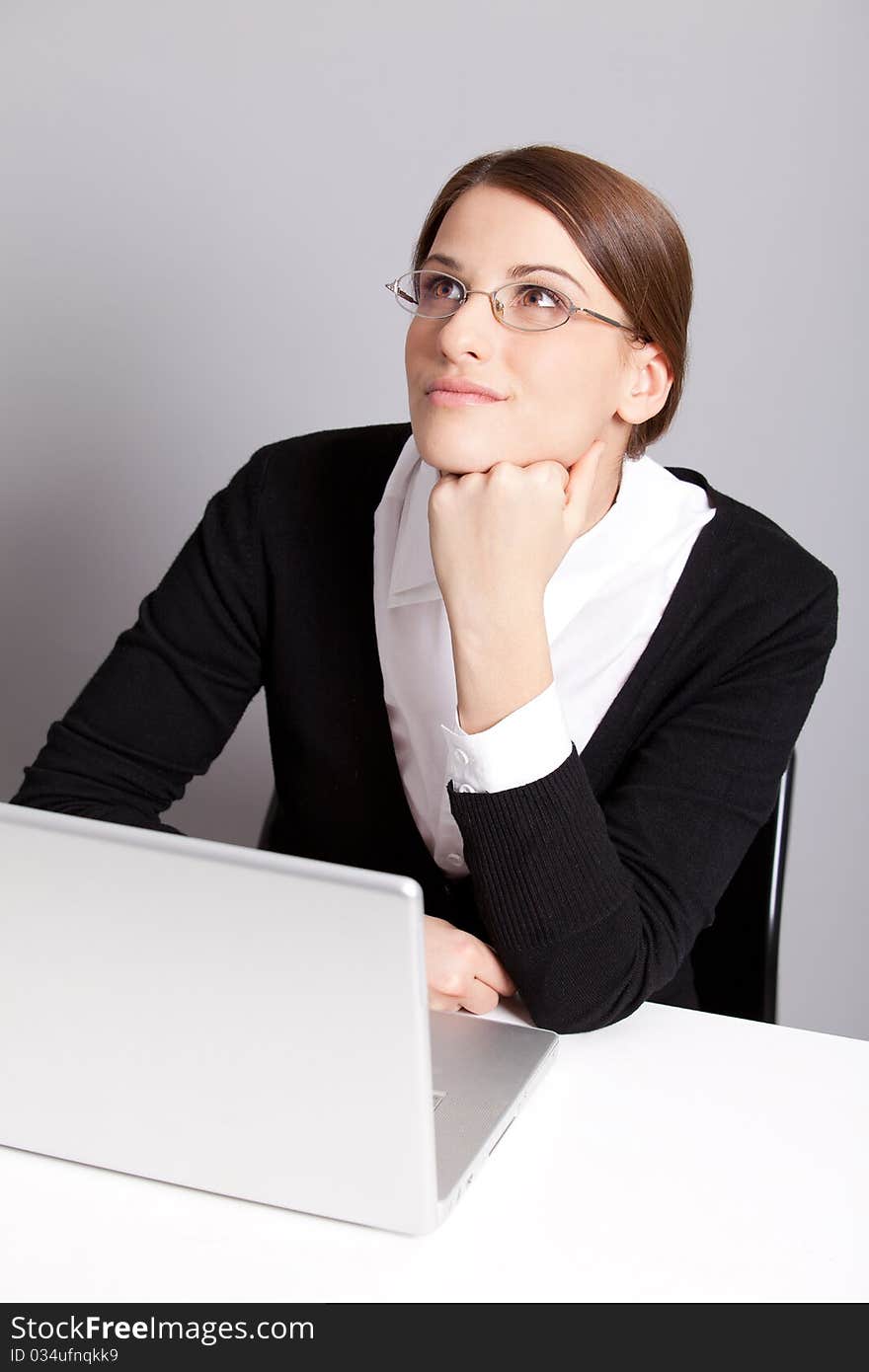 Thinking young office worker in glasses. Thinking young office worker in glasses