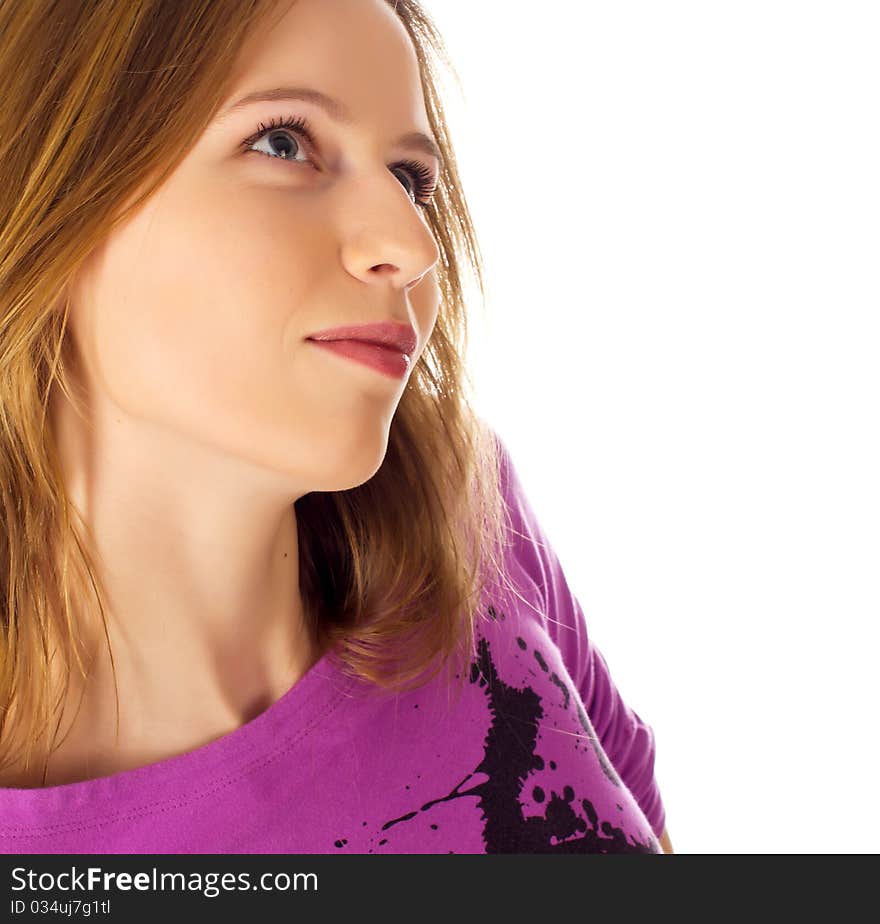 Pretty young woman looking away dreaming on white background