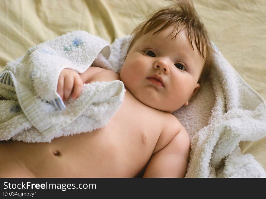 A little boy lying on sofa