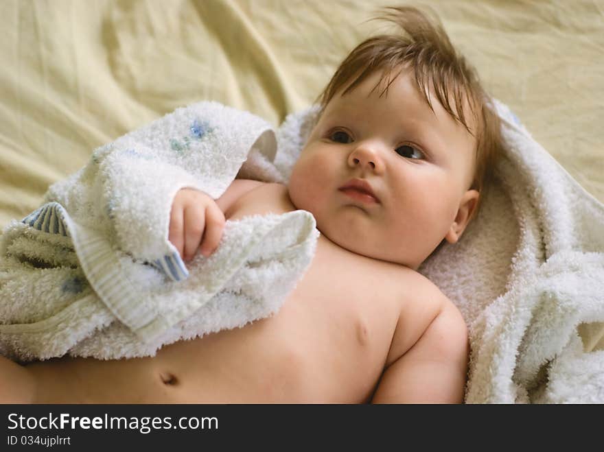 A little boy lying on sofa