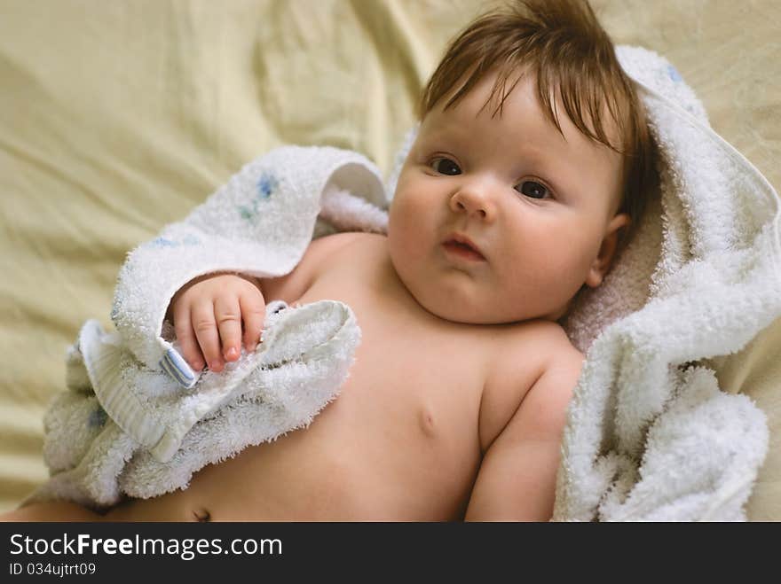 A little boy lying on sofa