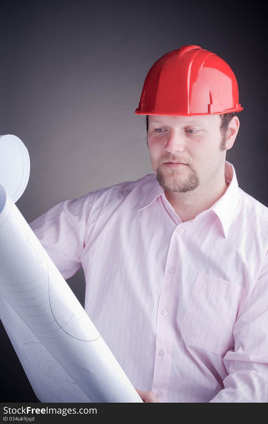 Construction engineer surveying the open project