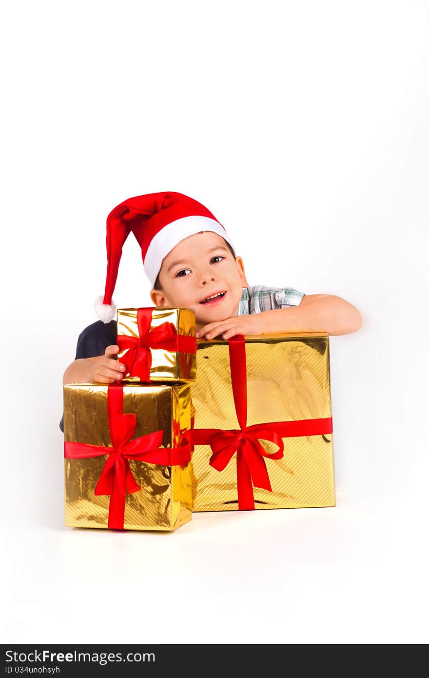 Little Boy In Santa Hat With A Bunch Of Gifts