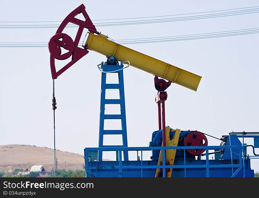 Close-up of an oil pump jack against clean sky. Close-up of an oil pump jack against clean sky.