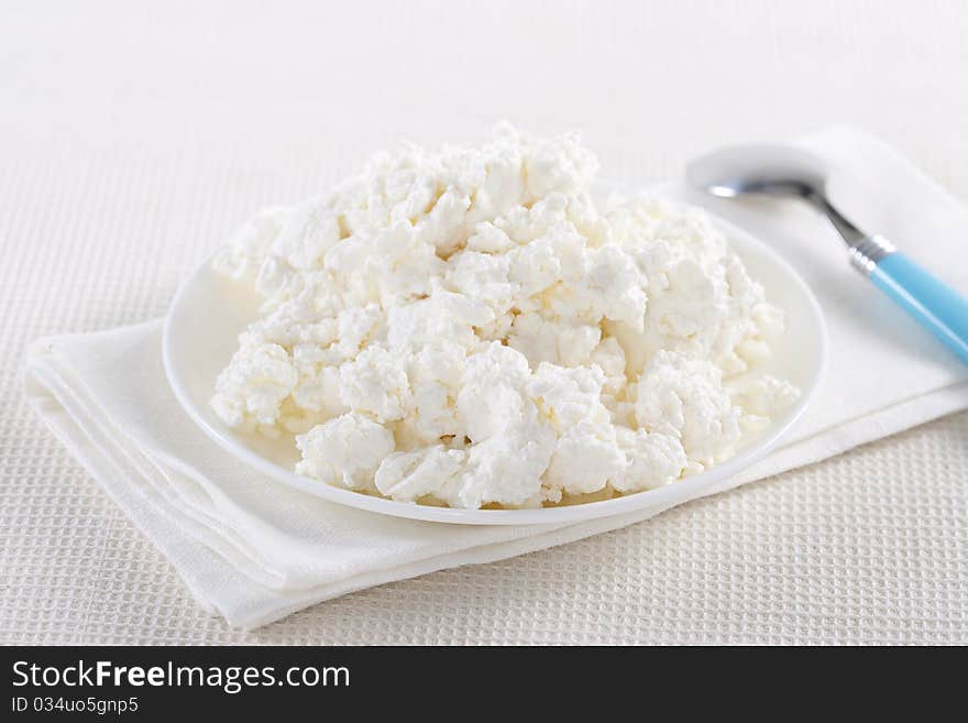 Fresh cottage cheese on the white plate