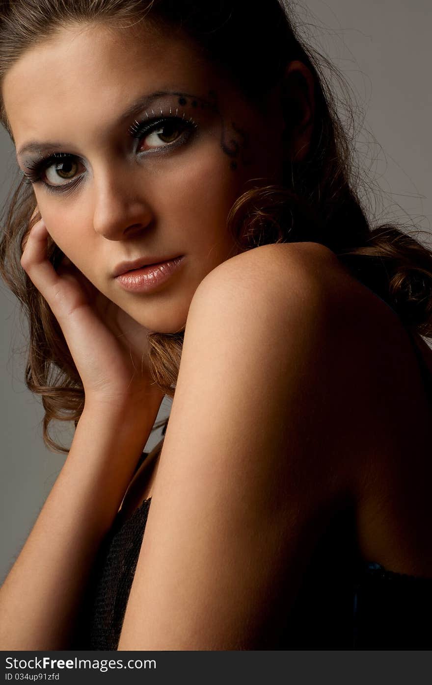 Portrait of a uoyng beautiful girl. Gray background. Studio shot. Portrait of a uoyng beautiful girl. Gray background. Studio shot.