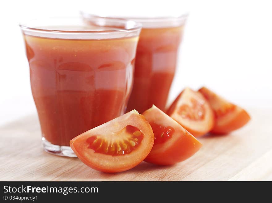 Fresh tomatoes and two glasses full of tomato juice. Fresh tomatoes and two glasses full of tomato juice