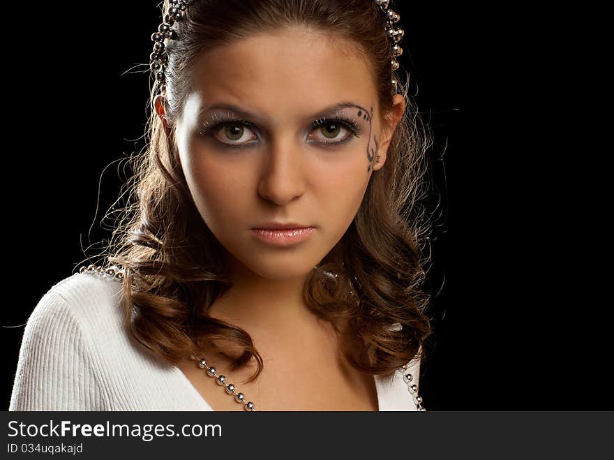 Portrait of a uoyng beautiful girl. Black background. Studio shot. Portrait of a uoyng beautiful girl. Black background. Studio shot.