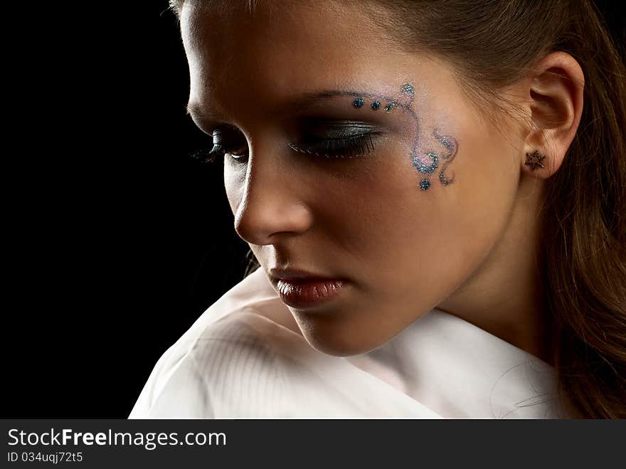 Portrait of a young beautiful girl. Black background. Studio shot. Portrait of a young beautiful girl. Black background. Studio shot.