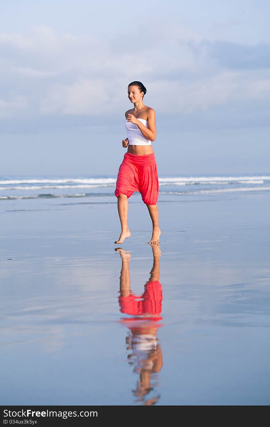 Beautiful woman running across the seaside. Beautiful woman running across the seaside