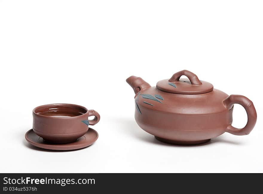 Clay tea pot: kettle and cut with green tea