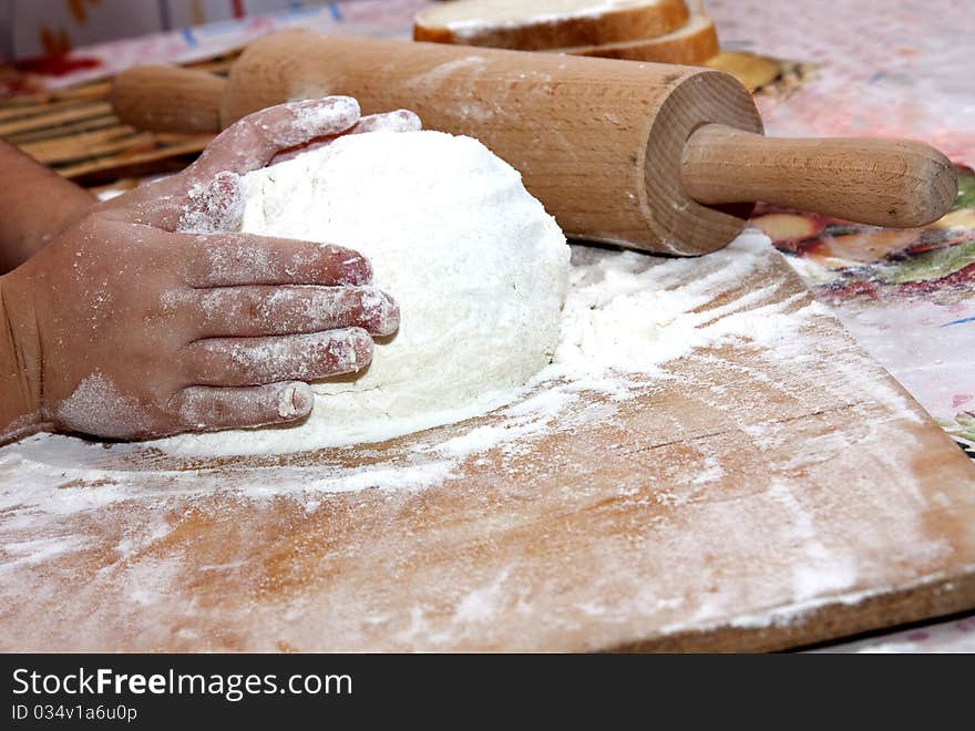 Knead the dough on the floured table. Knead the dough on the floured table