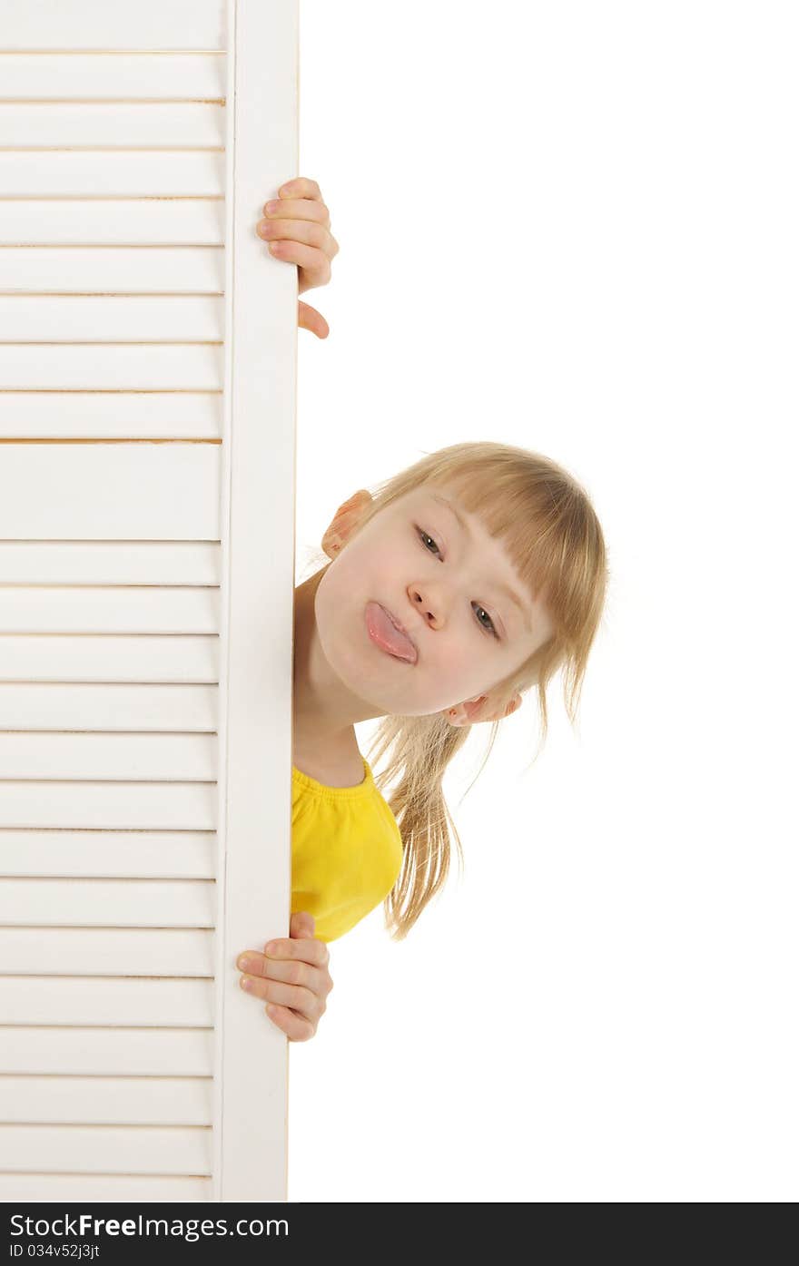 Girl puts out tongue in yellow jacket is isolated on the white