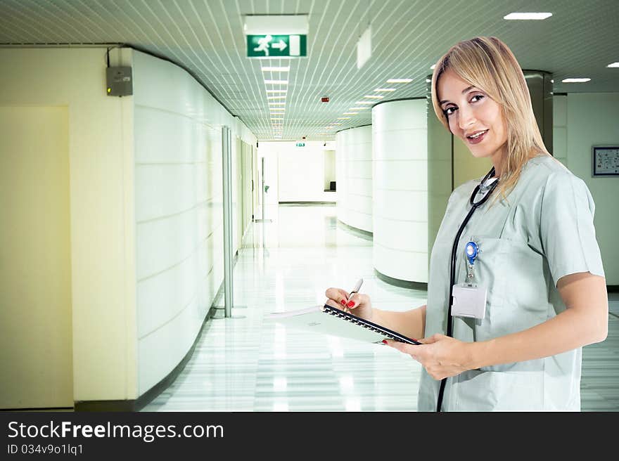 Smiling confident medical staff standing in her uniform. Smiling confident medical staff standing in her uniform