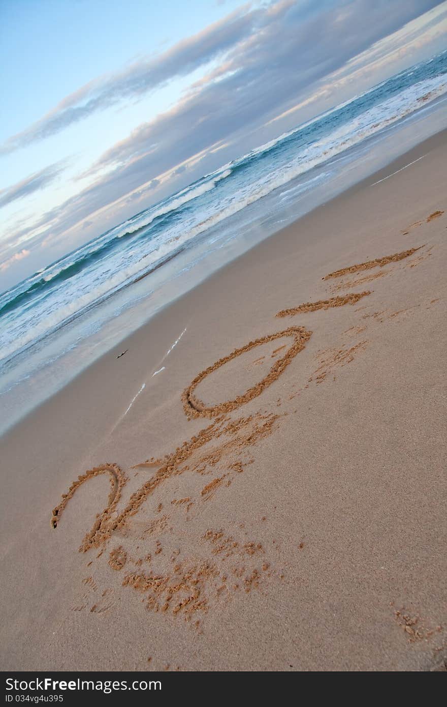 2011 written on sand beach with sea, new year. 2011 written on sand beach with sea, new year