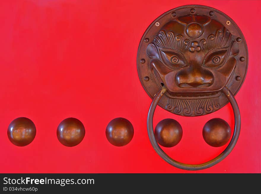 Chinese lion head door knocker on red door