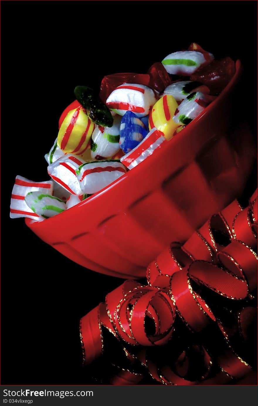 Red bowl,tilted,with traditional christmas candy. Red bowl,tilted,with traditional christmas candy