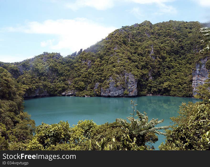 Hidden lake in the jungle surrounded by cliffs and trees,image was taken in Thailand