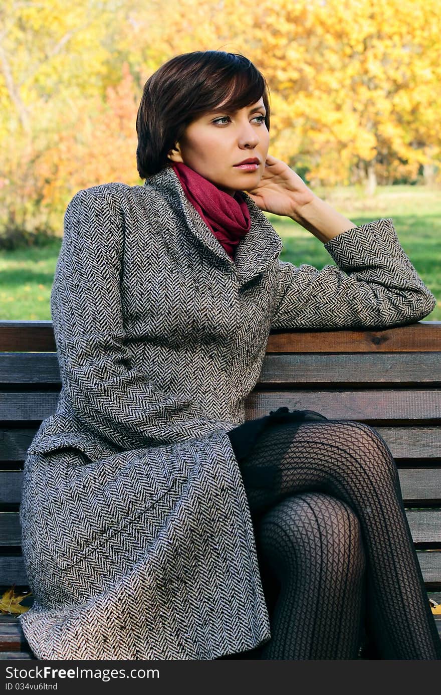 Woman in the autumn forest in the coat