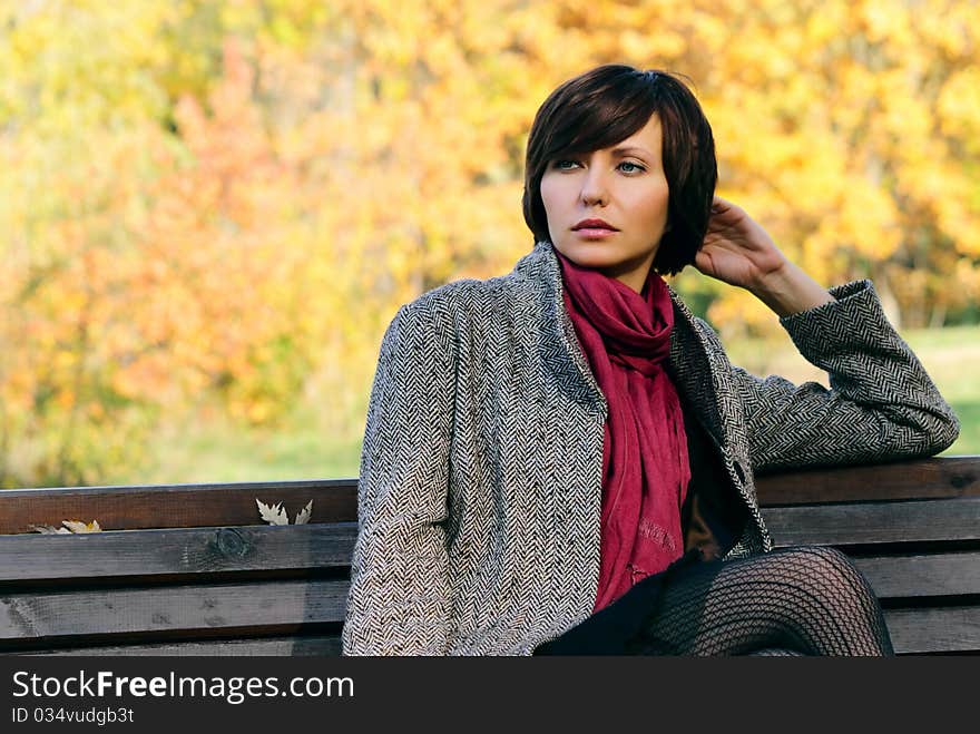 Woman in the autumn forest in the coat