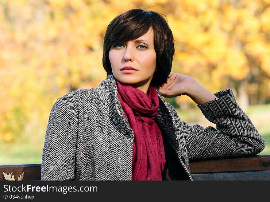 Woman in the autumn forest in the coat