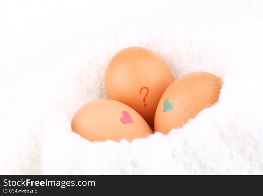 Three eggs lying down on a white background