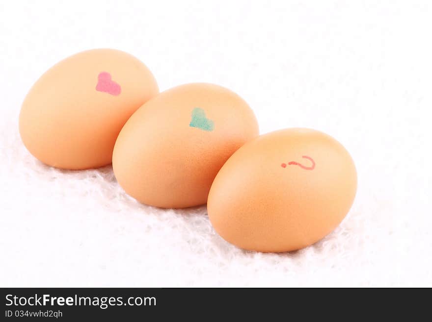 Three eggs lying down on a white background