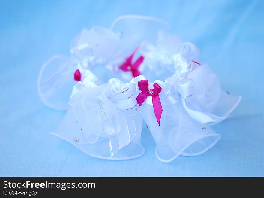 A delicate wedding garter waiting to be put on. A delicate wedding garter waiting to be put on