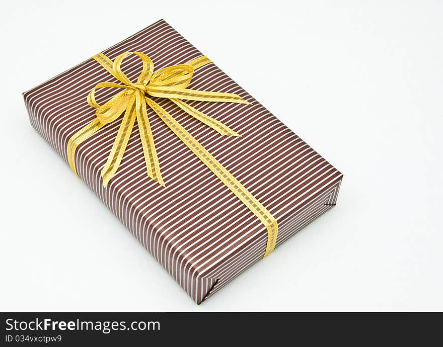 Black gift box with white bar attached gold ribbon