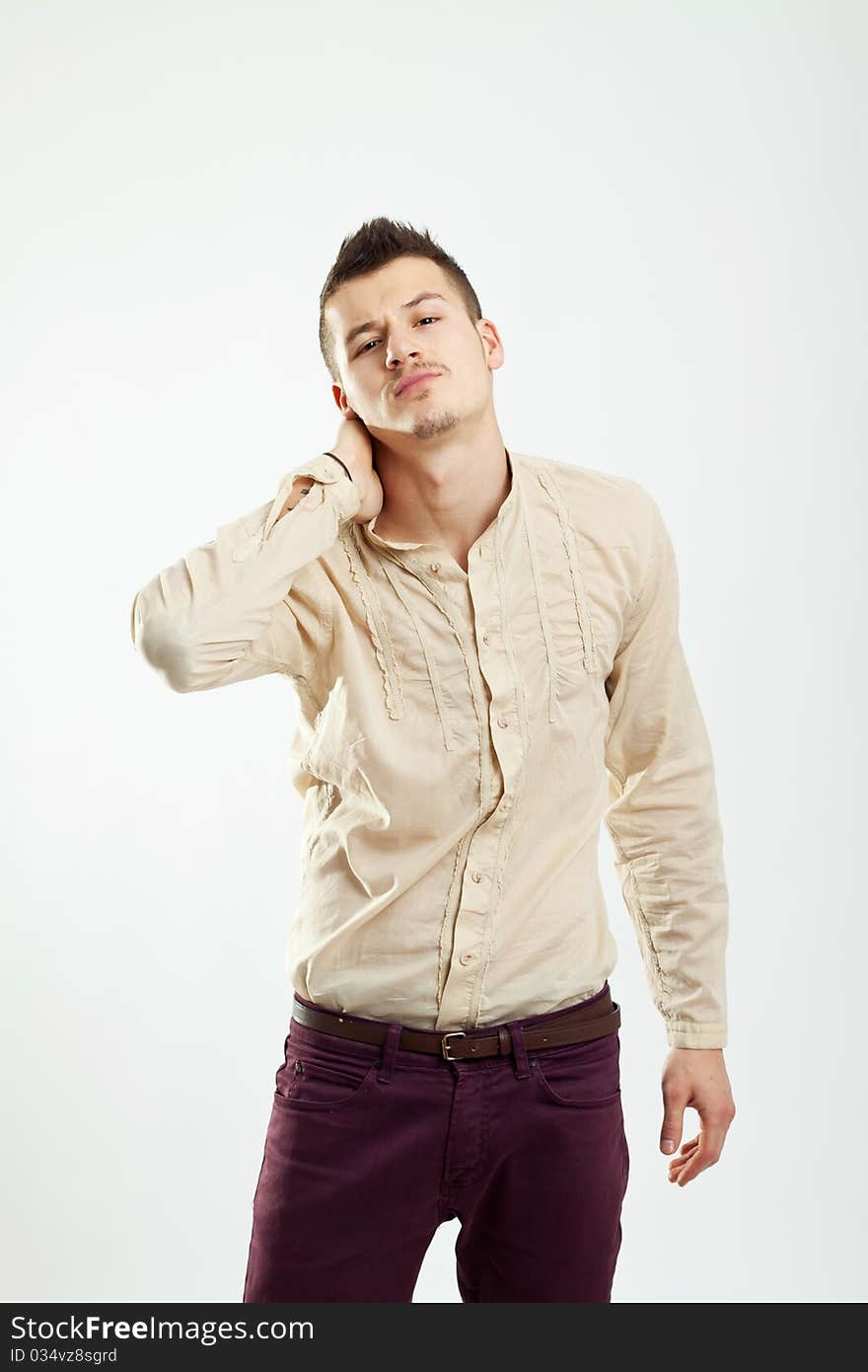 Handsome young man posing for the camera in studio