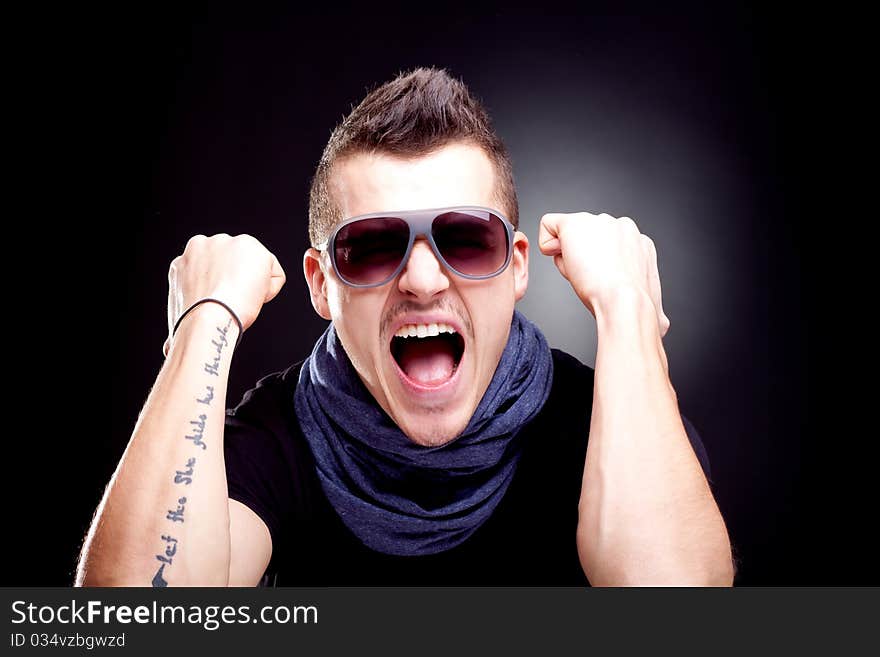 Man screaming with fists in the air - studio shot