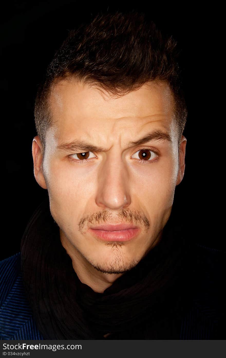 Good looking young man with eyebrow raised - studio shot