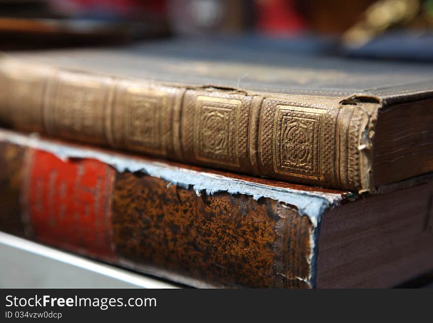 Two old books lying on a shelf. Two old books lying on a shelf