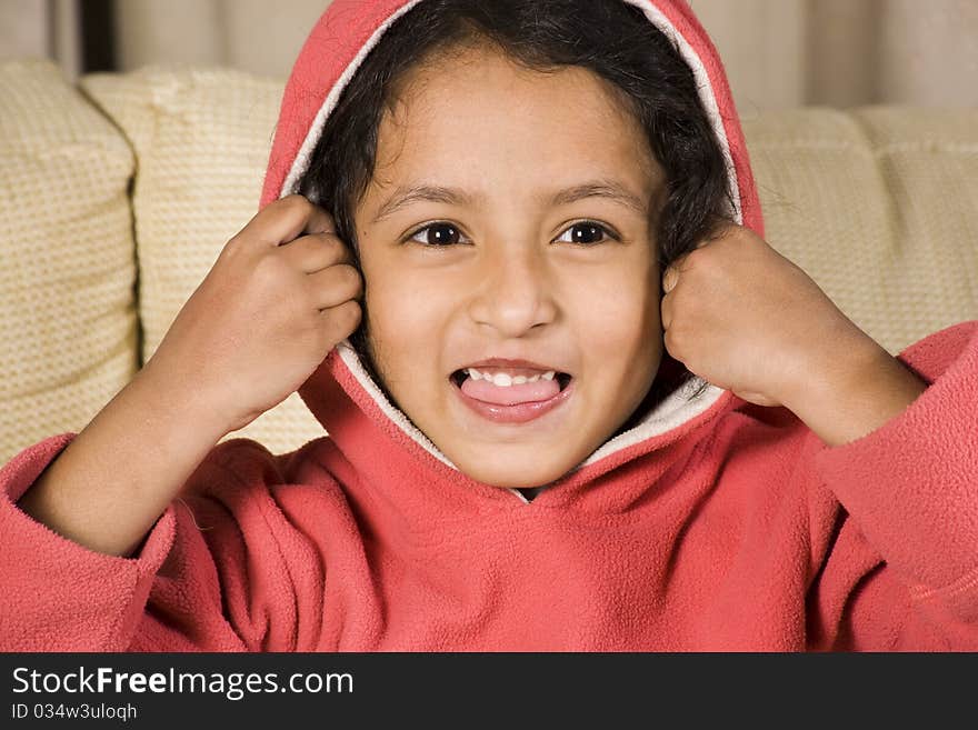 Cute little girl enjoying her winter hood. Cute little girl enjoying her winter hood.